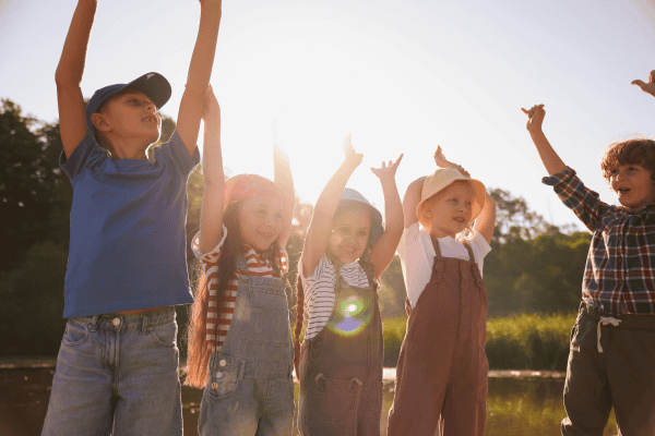 Children playing outdoors in sunlight, representing community and tradition, perfect for family and outdoor activity themes.