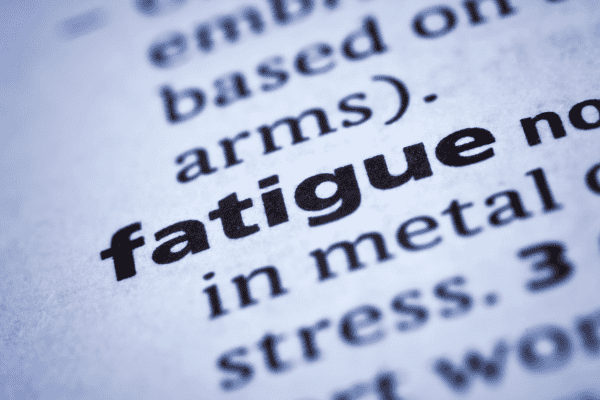 A detailed close-up of printed text discussing fatigue and stress, highlighting the importance of mental health and well-being, with a focus on mental health awareness and support.